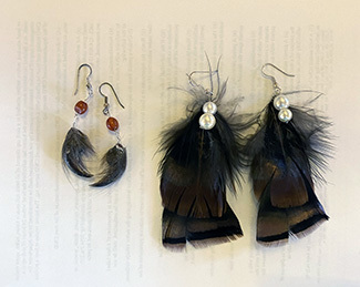 Earrings fashioned from parts of road-killed animals are shown.