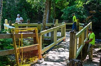 A work crew upgrades a viewing platform at Laughing Whitefish Falls in Alger County.