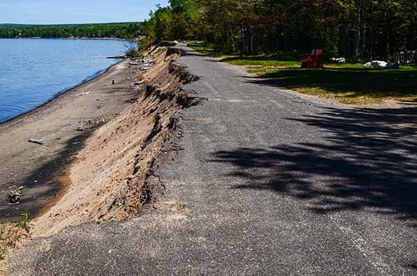 Storm damage, including an eroded road, is shown at F.J. McLain State Park in Houghton County.