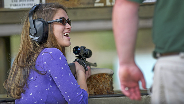 smiling woman at shooting range