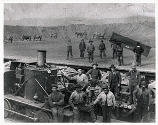 Miners pose with the Yankee locomotive at the Jackson Mine, Negaunee, circa 1880.