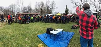 An organizer speaks to a large group of bikers at Sleepy Hollow State Park in Clinton County.