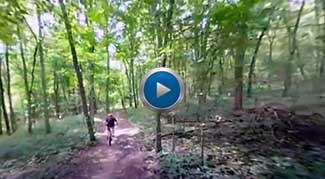 A video play button for Brad's DTE mountain biking video.