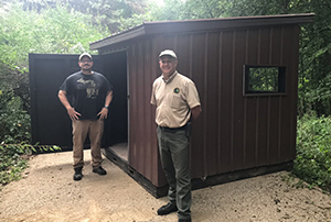 Tom Jones and Chuck Dennison standing near new accessible blind