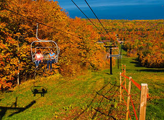 Two ladies on a ski lift enjoy the autumn leaf colors in Ontonagon County.