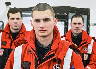Conservation officer Jeremy Sergey is shown with two fellow U.S. Coast Guardsmen in 2009.