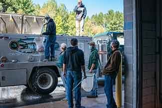 Arctic grayling are moved from a fish stocking truck to the Marquette State Fish Hatchery.