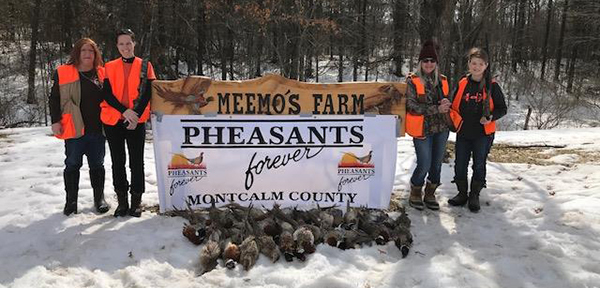 group of women with Meemo's Farm sign and harvested pheasants