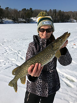 Story author Jennifer Johnson holds a pike she caught on AuTrain Lake in Alger County.