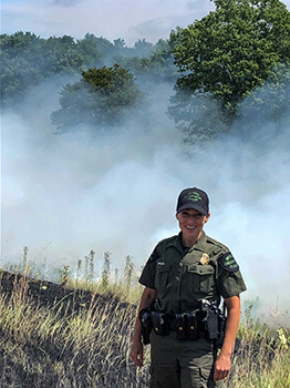 Michigan Conservation Officer Angela Greenway is pictured at the scene of a wildland fire.