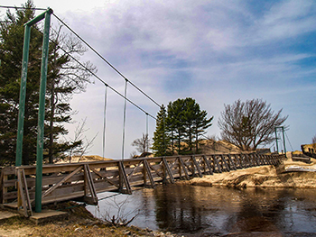 A walking bridge is shown over the Two-hearted River in northern Luce County.