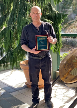 Brian Colter holds the Honors Award he achieved