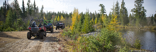 Three ORVs riding the trail