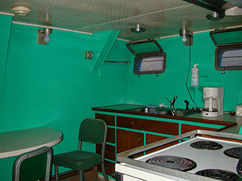 The basic green-colored galley aboard the Survey Vessel Steelhead is shown.