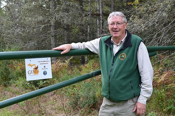 Al Stewart stands in front of a gate to the Goldmine GEMS in Iron County in 2015.
