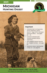 The front cover of the 2021 Michigan Hunting Digest featuring a historical photo of a woman holding a harvested pheasant with her hunting dog.