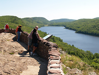 Visitors enjoy a sunny day at the Lake of the Clouds Overlook