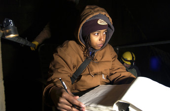 A researcher recording data during a bat hibernaculum survey at Tippy Dam.
