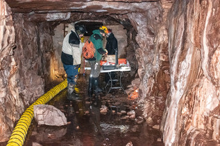 Workers are shown inside the mine shaft at the Carp Lake Mine.