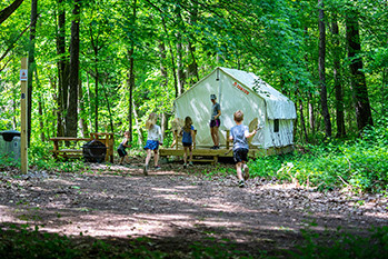 Campers are shown at a safari tent at Highland State Park.