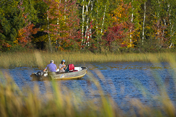 A man and a boy enjoy an autumn afternoon boating on a lake in Luce County.