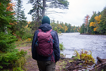A hiker walks along the waters of the Tahquamenon River in the Upper Peninsula.