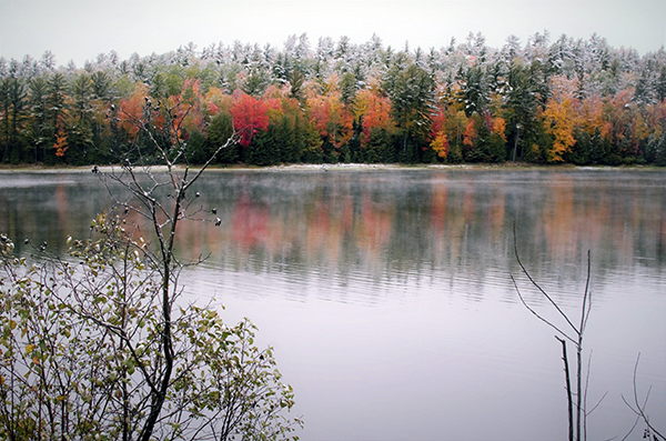 An October snowfall covers the colorful autumn leaves on Deer Lake in Marquette County.