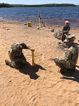 A Michigan Army National Guard survey crew works along the shore of Silver Lake in Marquette County.
