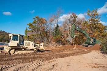 Heavy equipment is shown moving dirt at the Silver Lake boating access site project in Marquette County.