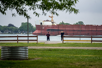 couple watching freighter go by
