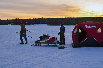 Ice fishermen enjoy an early morning outing on Huron Bay in Baraga County.