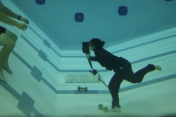 A female cadet completes an underwater training exercise in a swimming pool as part of a recent Michigan DNR conservation officer academy.