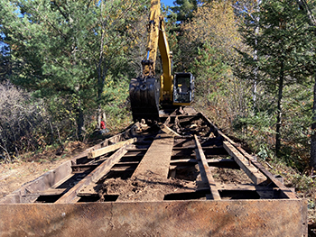 The old decking is being removed from the old bridge supports.