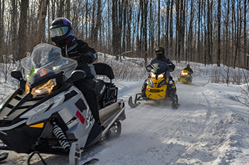 Three snowmobilers take a morning ride in Gogebic County.