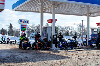 Snowmobilers gas-up their sleds at a service station in Ontonagon County.