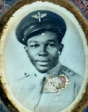 black-and-white image, with a rough oval matte, head-and-shoulders portrait of a uniformed Tuskegee Airman. Photo shows some wear from age.