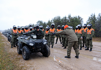 A photo shows conservation officers in off-road vehicle training at the academy.