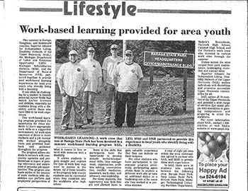 A newspaper article is reproduced highlighting the work of Michigan Rehabilitation Services enrollees.