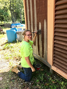 A Michigan Rehabilitation Services enrollee works on a painting project at F.J. McLain State Park.