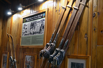 An interior photo of vintage skis and other memorabilia at the Porcupine Mountains ski chalet.