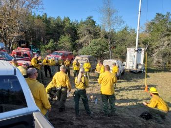 DNR fire staffers gather for a briefing and orders