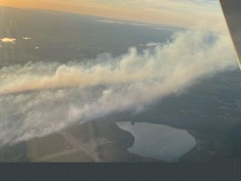 Smoke and a local lake are seen in a spotter plane image