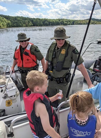 Officers and children on boat