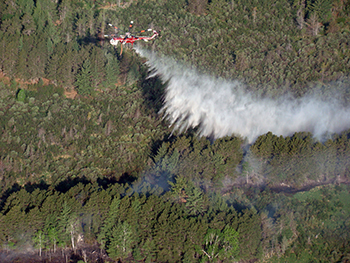 A helicopter aids in the suppression of the Duck Lake Fire.