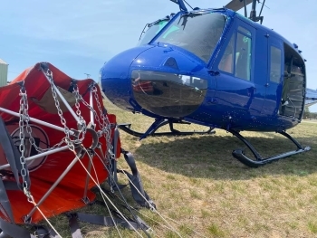 A Michigan Stae Police helicopter teamed with a DNR "Bambi Bucket" is now a key tool available for fighting wildland fires. 