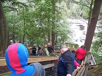 Participants in bucket brigade lined up on stairway leading to Tahquamenon River