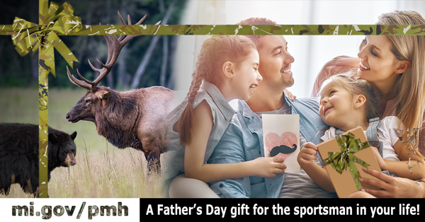 Mother and two daughters giving father a wrapped gift and card for Father's Day. Bear and elk are seen superimposed off to the side. 