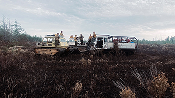 Firefighters are shown on tracked marsh vehicles at the Creighton Marsh Fire in Schoolcraft County.