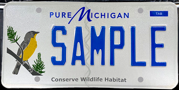 a white license with lettering that says Pure Michigan and Conserve Wildlife Habitat, image of a yellow bird on a pine twig at the left