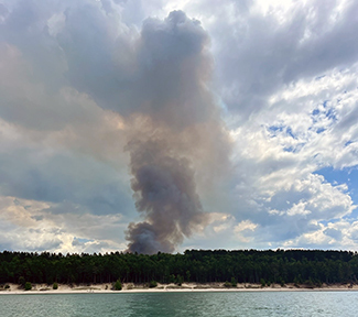 A smoke plume from the wildfire is shown from Lake Superior, off Twelvemile Beach in Alger County.